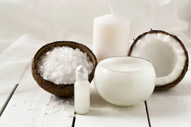Spa products with coconut: sea salt, coconut oil, foam, coconut, scented candle