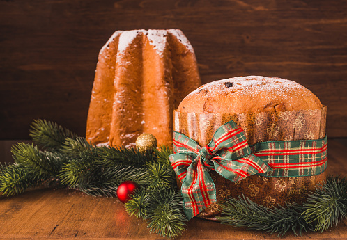 Pandoro sweet bread and Panettone cake traditional Italian Christmas sweet on wooden background copy space.