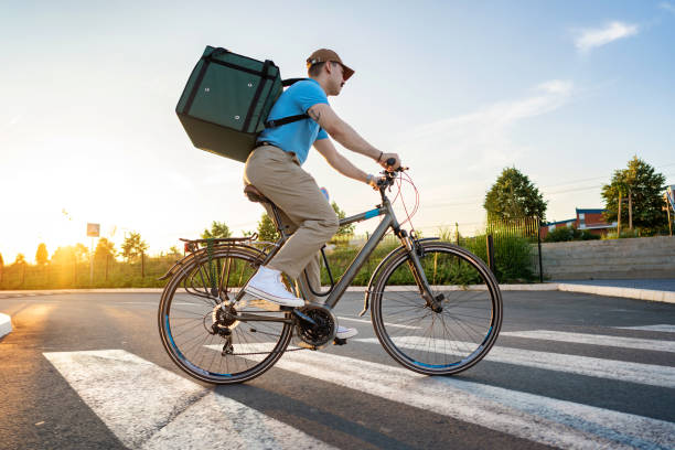 istock Courier On Bicycle Delivering Food In City 1402535414