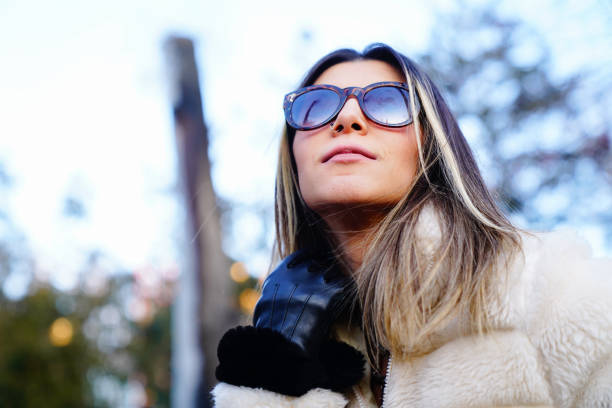 Stylish young woman in sunglasses smiling