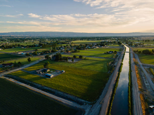 istock Large Irrigation Canal Running Through a Dry landscape at Dusk with a Dramatic Sky 1402538525