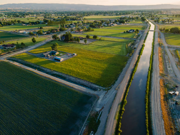 istock Large Irrigation Canal Running Through a Dry landscape at Dusk with a Dramatic Sky 1402538574
