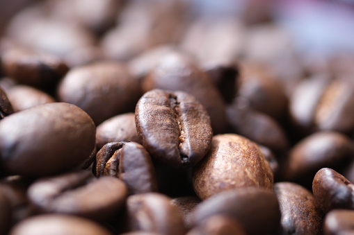 Coffee roasted beans  closeup, coffee macro close up, selective focus. Defocused natural blurred background.