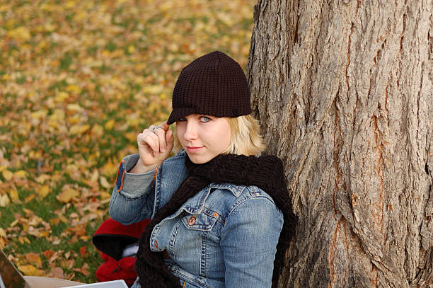 Young woman outdoors wearing hat. stock photo