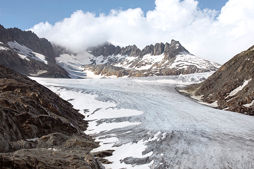 Melting Rhone glacier in Swiss Alps. End of the glacier melting into a lake.