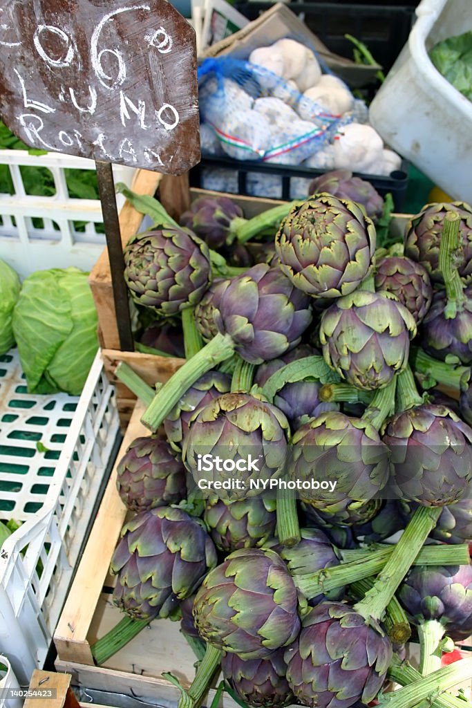 Artichokes at Market Rome's open-air markets have the freshest produce in the city; these artichokes still have stems on them! Artichoke Stock Photo