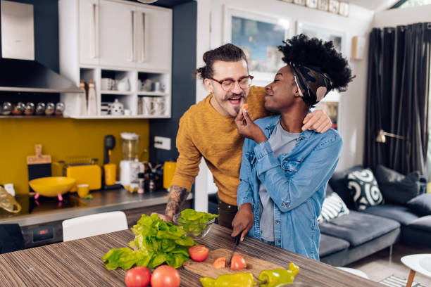 istock Happy multi-ethnic couple having fun while cooking their vegan dinner 1402545612