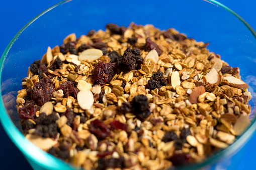 Homemade granola in a glass jar with selective focus, healthy vegan snack