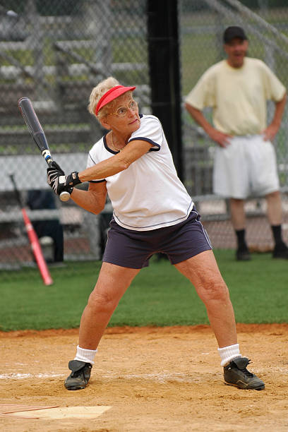 A softball player preparing to bunt.