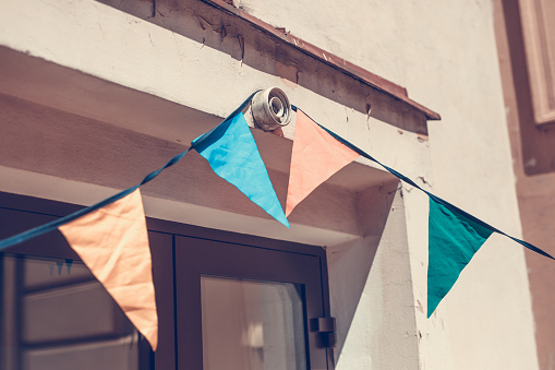 Birthday flags. They hang in the background of an old tenement house Krakow in Poland.