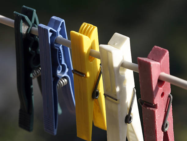 Plastic colored clothes pegs stock photo