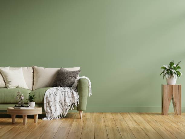 istock Interior wall mockup in dark tones with green sofa on green wall background. 1402551696