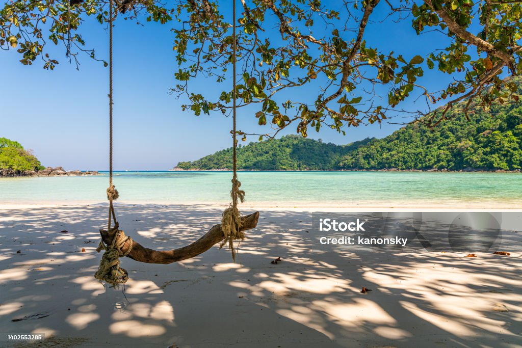 Wooden swing on beautiful white sand beach, Surin island national park, Phang nga, Thailand Wooden swing on beautiful white sand beach, Surin island national park, Phang nga, Thailand. Island Stock Photo