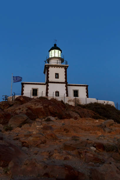 istock The old lighthouse on the rocky cliff at night. 1402553293