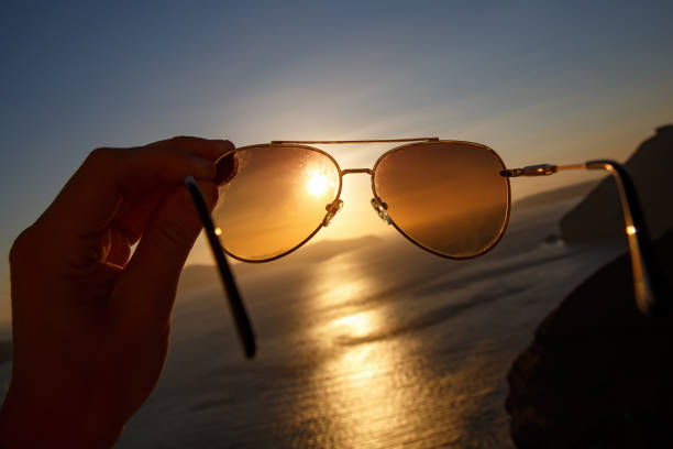 istock Aviator sunglasses in a hand during vacation. 1402553333