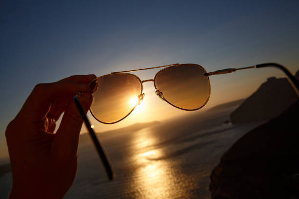istock Aviator sunglasses in a hand during vacation. 1402553337