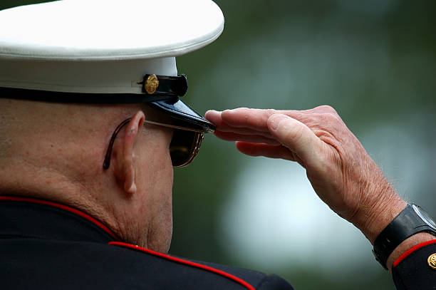 Old Marine Salutes Close up of an elderly retored Marine saluting marines stock pictures, royalty-free photos & images