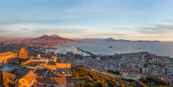 Wide angle view of City of Naples, mount Vesuvius and Gulf of Naples from the top of San Elmo Castle in the evening