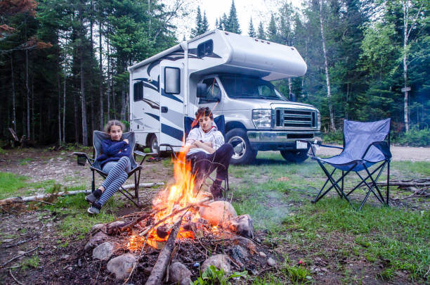 istock Girl and boy looking at campfire 1402560276