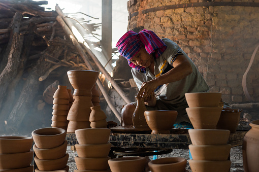 Thai male potter Inherited the art of pottery from the old be a craftsman in the city of Ubon Ratchathani Province, Thailand