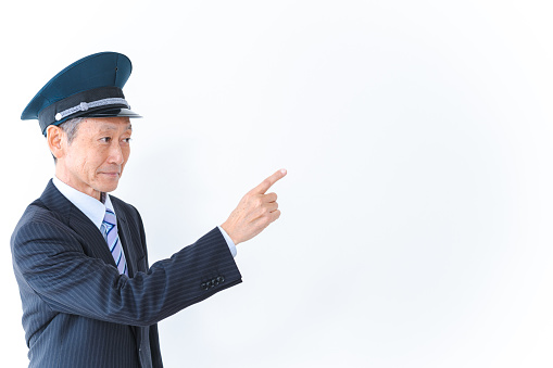 Elderly conductor pointing and checking