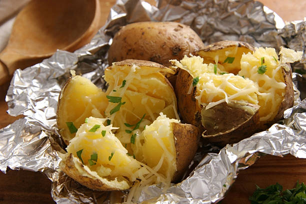 Baked potatoes. Baked potatoes with butter and cheese. baked potato stock pictures, royalty-free photos & images