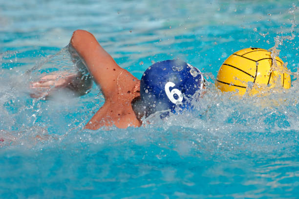 Water polo player Water polo player swimming for the ball water polo photos stock pictures, royalty-free photos & images
