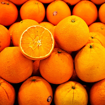 Half of orange on the heap of oranges