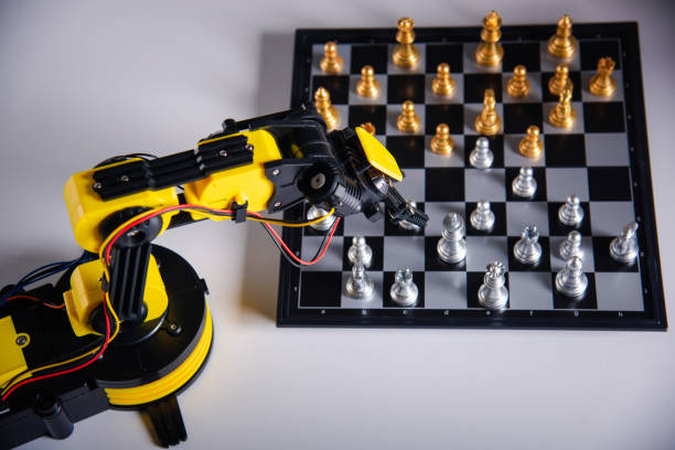 istock Closeup yellow robot arm playing move chess on chessboard 1402571582