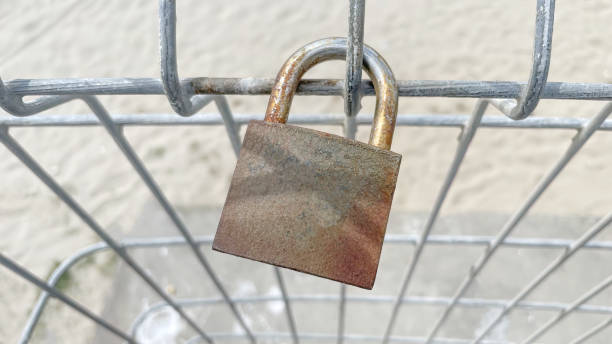 istock Rusty lock on metal fence in nature 1402573097