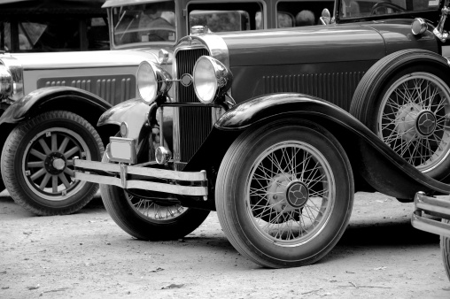 A line up of vintage cars in black and white