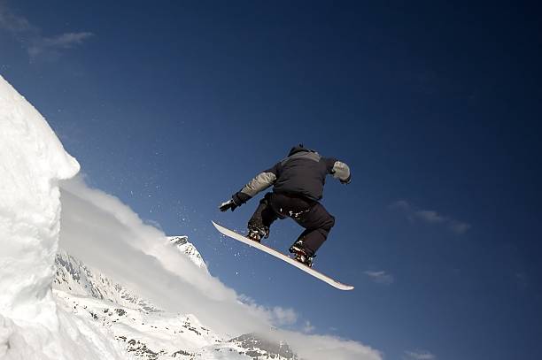 istock snowboarder jumping high in the air 140257410