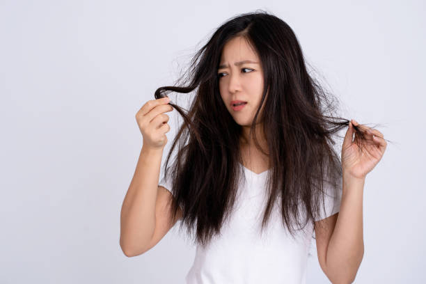 istock Sad Asian woman have hair problem. 1402576548