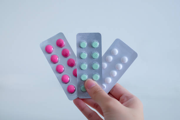 istock A hand holding many different type of capsules or medicines. 1402581081