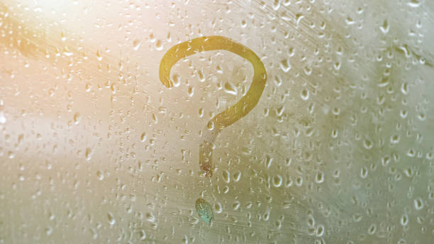 istock question mark on misty glass in rainy weather 1402583980