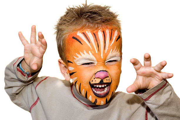 Angry lion Kid with lion painted face. On white background. face paint stock pictures, royalty-free photos & images