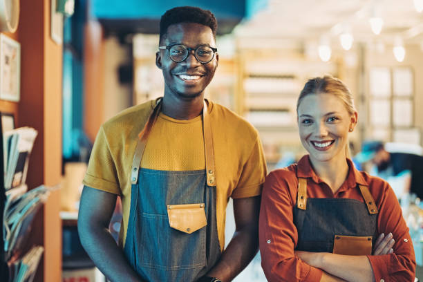 istock Young cafeteria owners standing side by side and smiling 1402585992