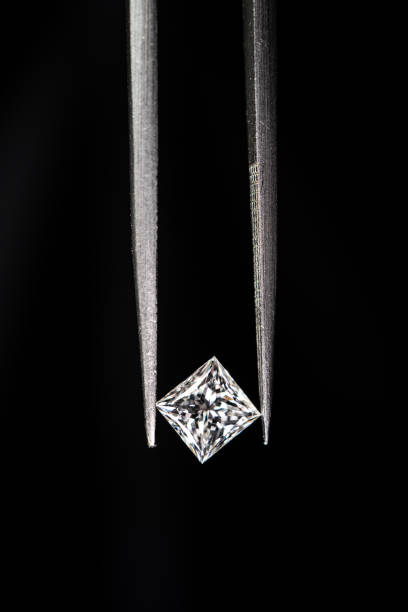 istock Princess cut diamond with tweezers 1402587409