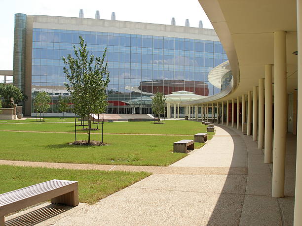 Modern glass building with curved walkway