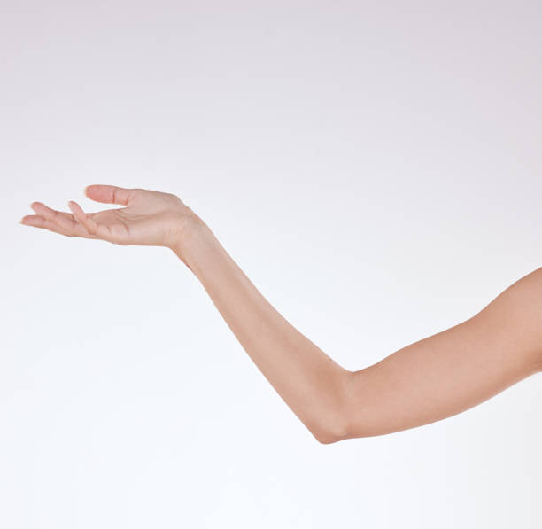 closeup of unrecognizable mixed race with soft skin posing against a white copyspace background. unknown hispanic woman's hand reaching out after a beauty treatment - elbow imagens e fotografias de stock