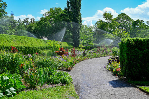 water sprinklers in public garden called city garden orebro sweden - city of tool imagens e fotografias de stock