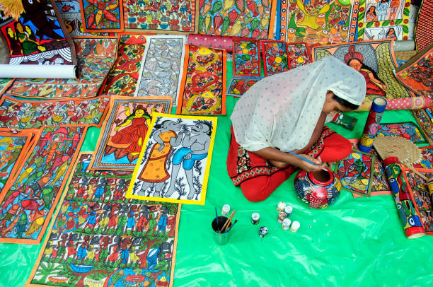 Pingla,west Medinipur, west Bengal 11/30/2012 A traditional Pot painter is busy to painting a earthen pot, in a traditional village art and craft fair.