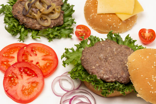 istock Fried burger bun on lettuce leaf, fried burger with cheese and fried onions, chopped tomatoes and onions. 1402591496