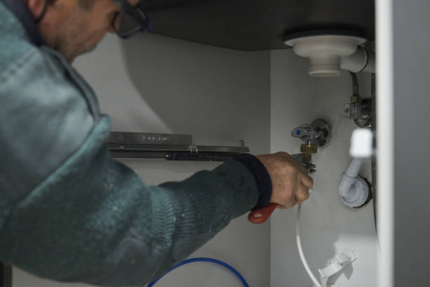 istock Mature technician connecting water to american fridge using a wrench. 1402592861