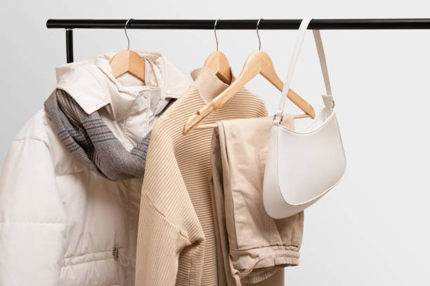 istock Basic autumn women's wardrobe concept on railing in showroom. Woman collection of clothes on a rack. Autumn fashion trending concept. Railing with stylish female clothes, clothing retails concept. Fashion blog, social media. 1402594607