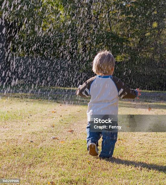 Small Boy Running In The Rain Stock Photo - Download Image Now - 12-17 Months, Child, Drenched