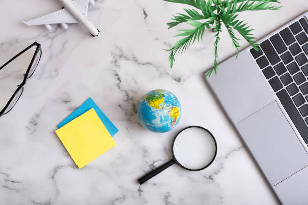 istock Travel flat lay composition on working table laptop, airplane, globe and note papers. Trip prepare concept 1402596872