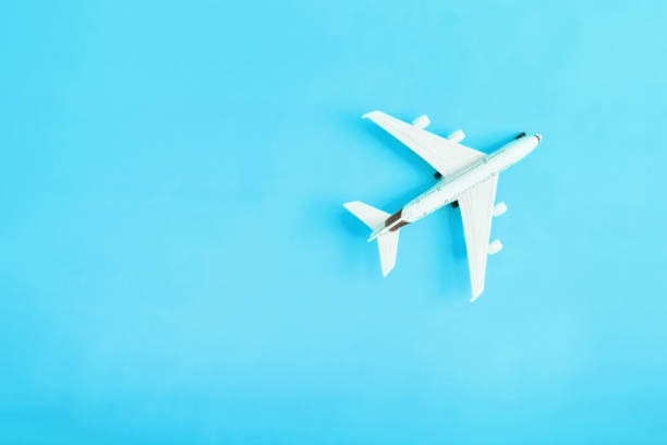 istock Travel flat lay composition airplane on yellow background with copy space 1402596993