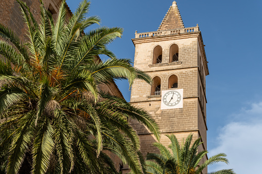 Bell tower with clock of the parish church of the Majorcan town of Porreres, Spain