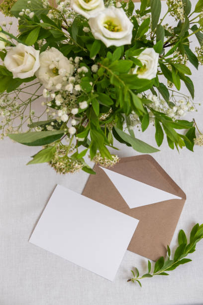 istock Wedding invitation card template on white background. Blank greeting cards and envelope. Elegantly decorated table at a wedding reception. Top view 1402599921
